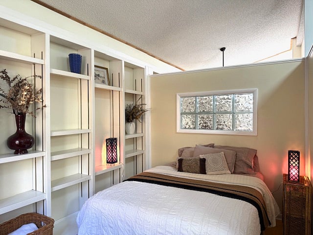 bedroom with shelving queen bed linens included 
