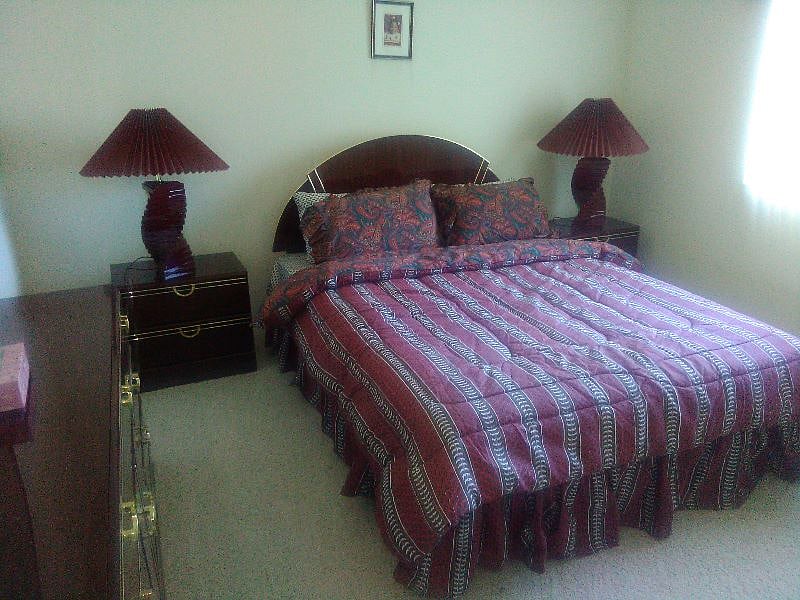 Full size bedroom with closet and window