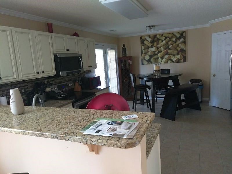 Fully Equipped Kitchen with flat top stove and built in microwave.