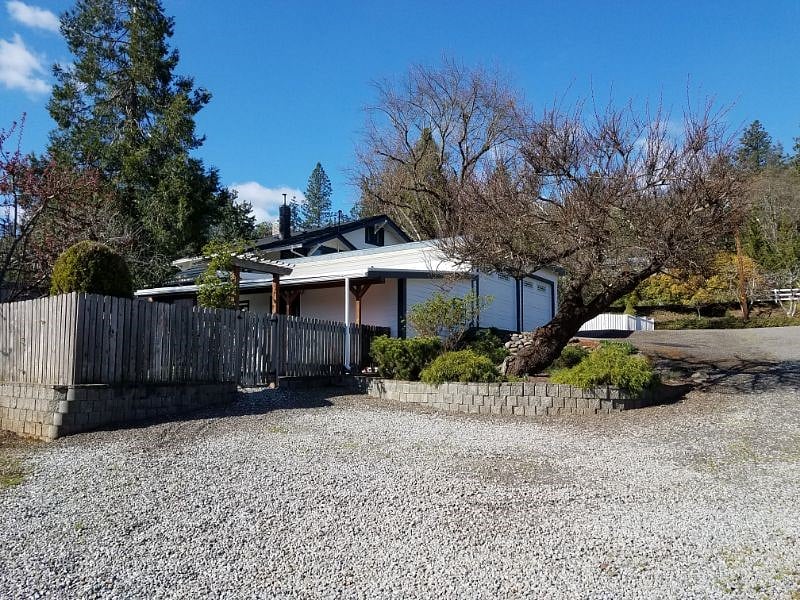 Side view of cottage with parking.