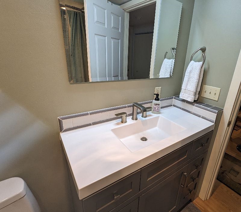 Bathroom is furnished with towels, soap and more.