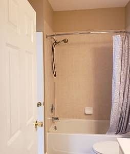 Here's your full-sized shower with an adjustable showerhead and curved shower rod for maximum space.