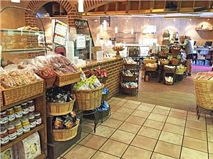 French bakery and coffee shop at corner along with other eateries, shops and spa.