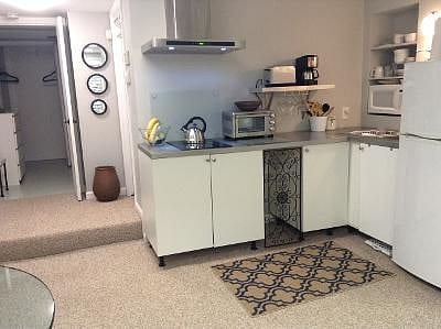 Kitchen with appliances, cookware,  dishes, utensils, spices, garbage bags, cleaning supplies.  