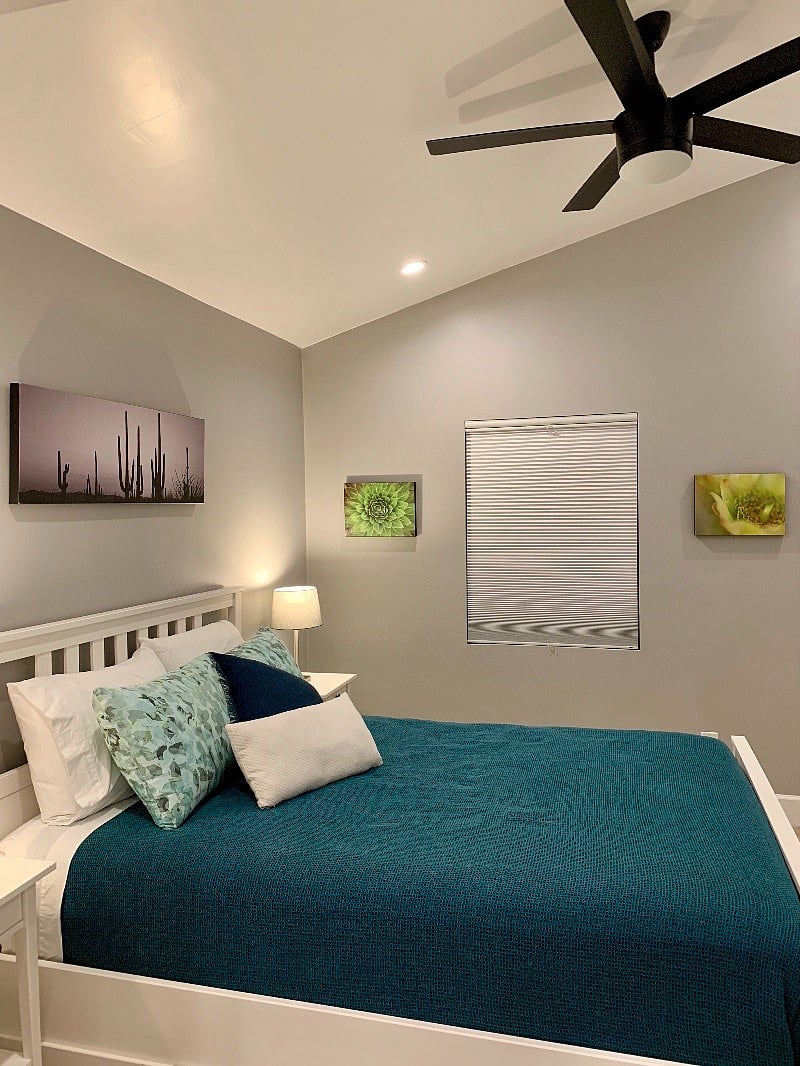 Comfortable queen bed with ceiling fan. Bedroom has blackout cell shades for darkness conducive to sleeping in.