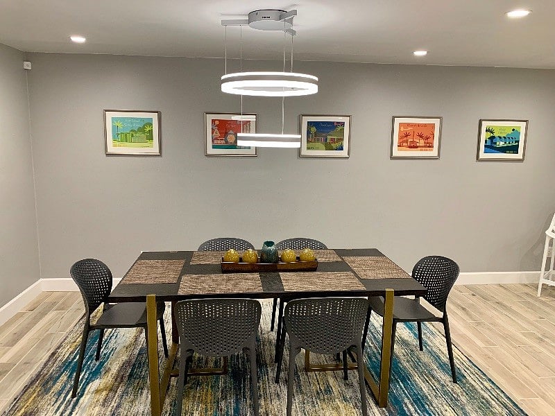 Dining table with modern dimmable light fixture. 
