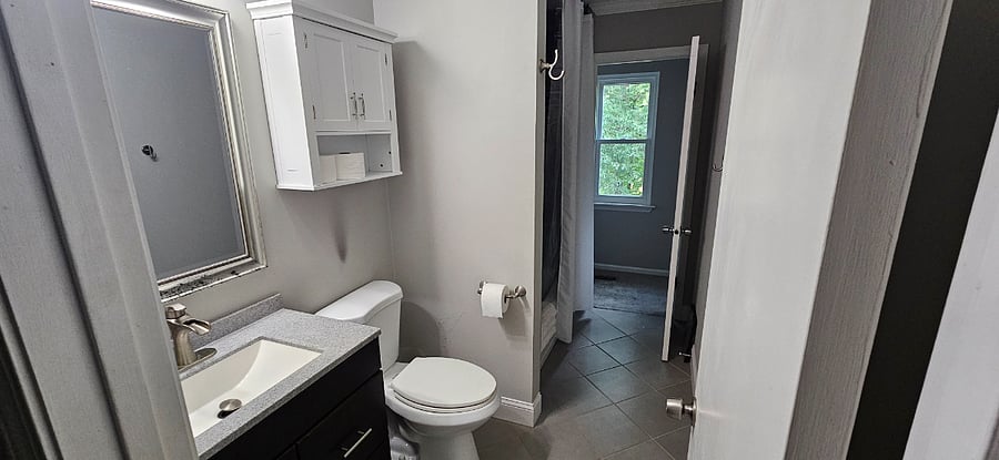 The upstairs bathroom is shared by both bedrooms.