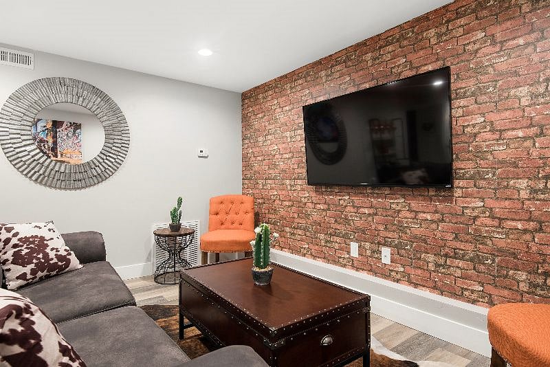 The lilving room has a smart TV with Direct TV DVR.