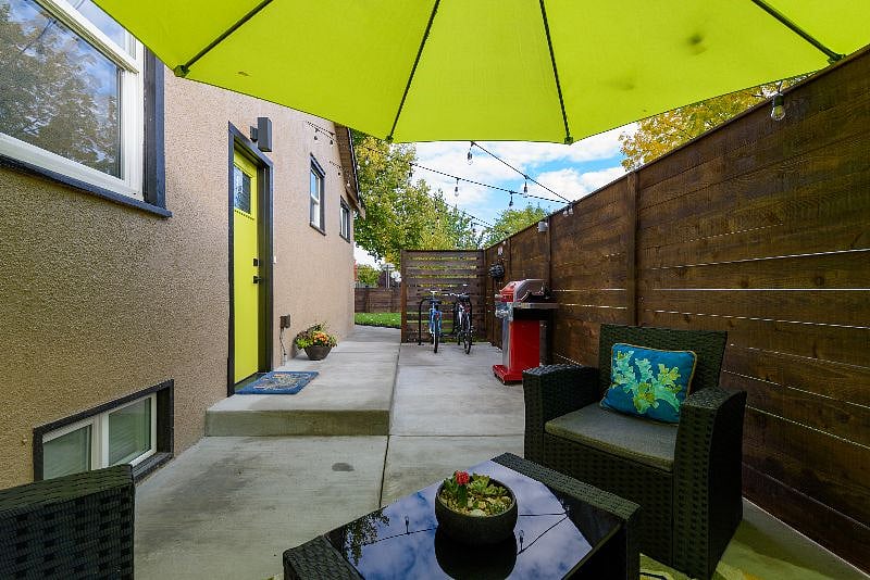 Patio area features plenty of seating, a BBQ, bike rack and bike for your use.