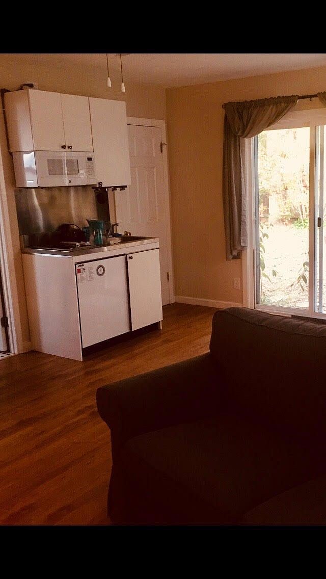 mini-kitchen with stove top, microwave, fridge