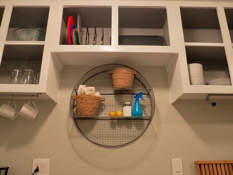Over the sink area with open cabinets. 