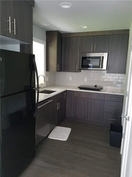 Unit has a full kitchen with full-size refrigerator and washing machine