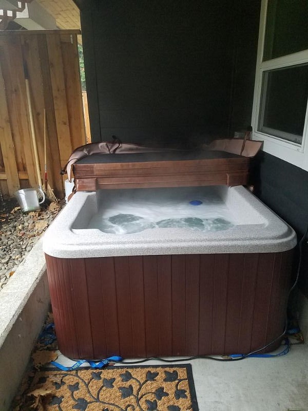 Hot tub on the patio just outside the unit.