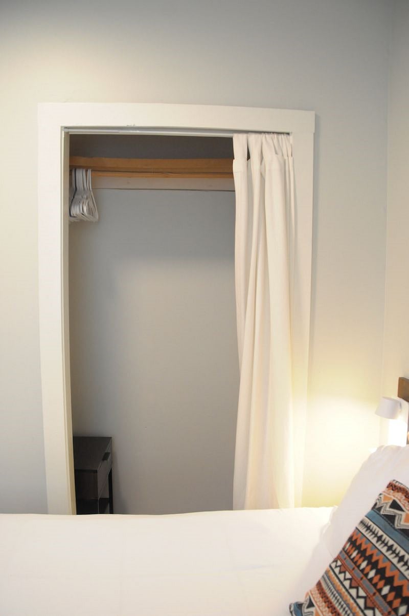 Closet with hangers and a small table