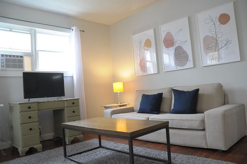 Unit comes with an air conditioning window unit in the living room