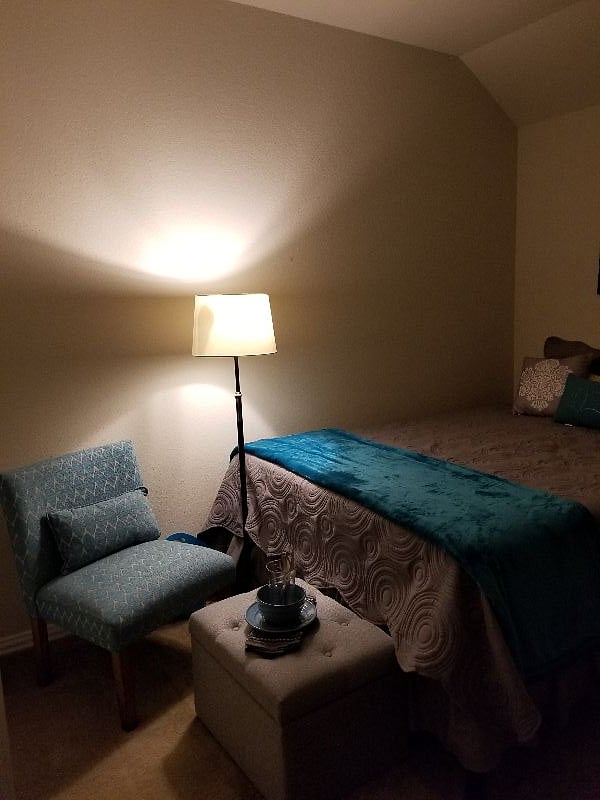 Lounge chair, ottoman, and large closet with dresser. On top dresser microwave & toaster
