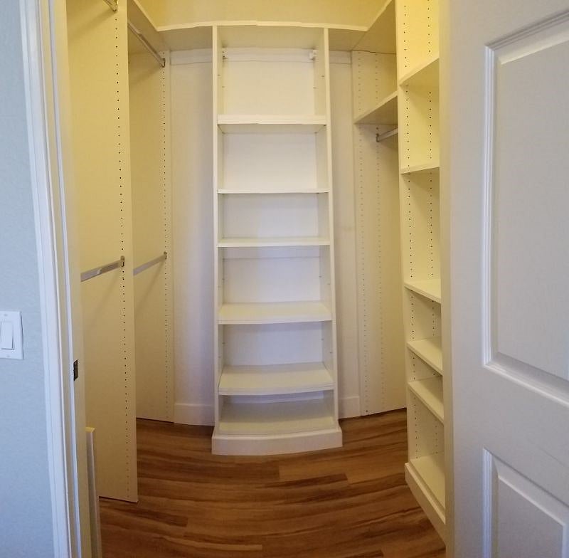 Private walk-in closet with adjustable shelves (distortion due to panorama mode)