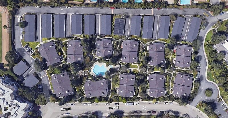 Aerial view of the complex. Lots of green, outdoor space, plenty of parking.