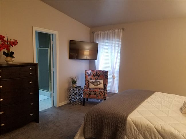 Master bedroom with flat screen TV.