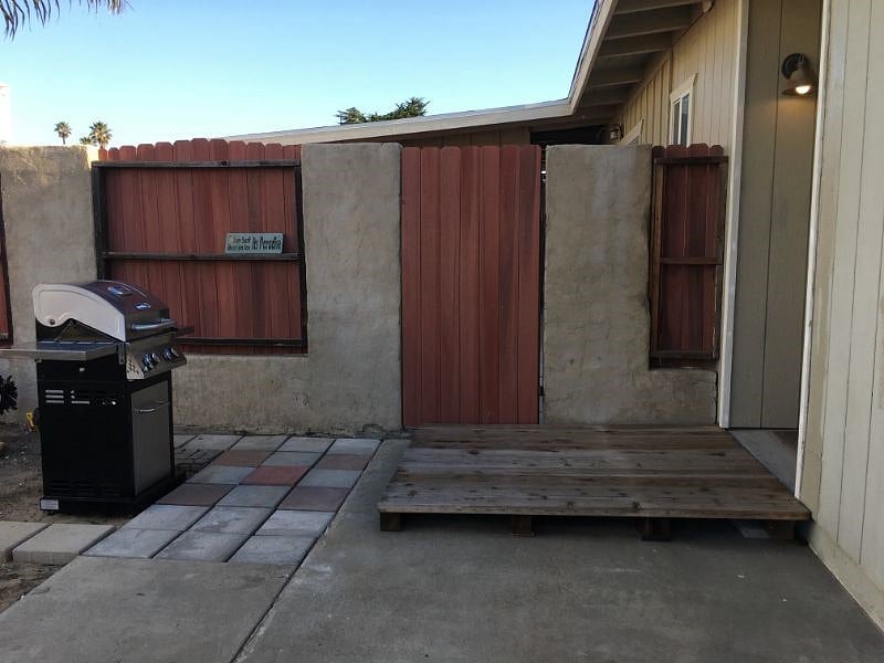 Fenced outside yard with BBQ.