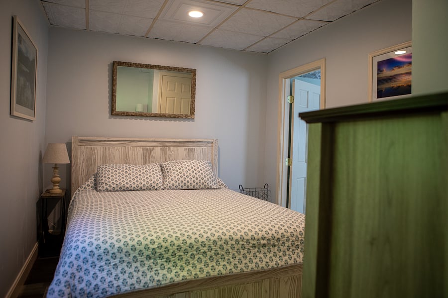 The bedroom has a queen sized bed