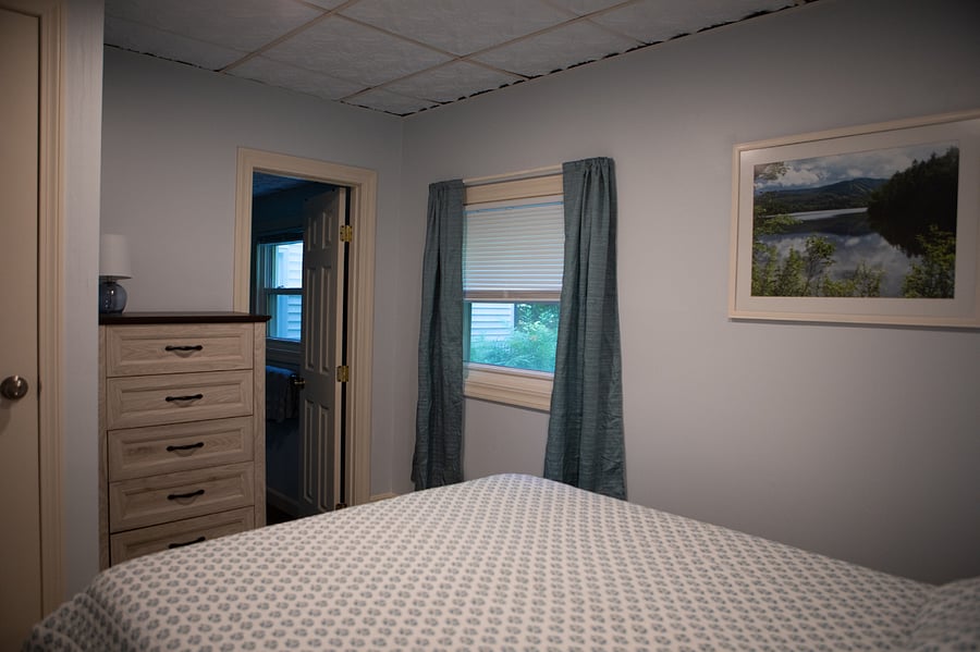 The bedroom has a queen sized bed