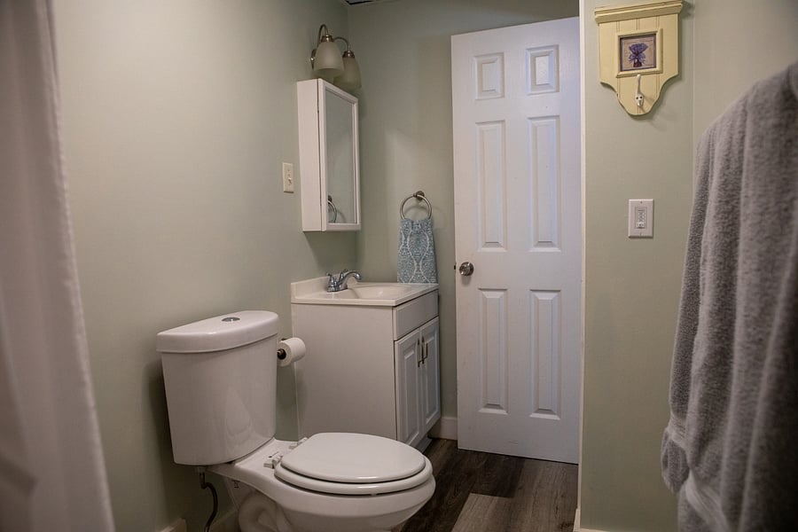 The bathroom has a tub and shower and has new flooring and paint and has a light with a Bluetooth speaker so you can listen to music/podcasts while you get ready.