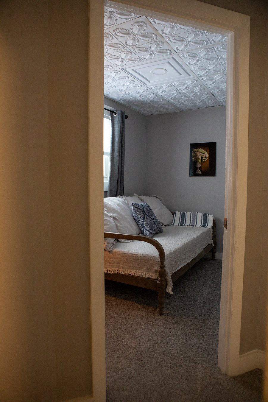 This is the small bedroom. It has a day bed, a night stand a closet and a window but is quite small.