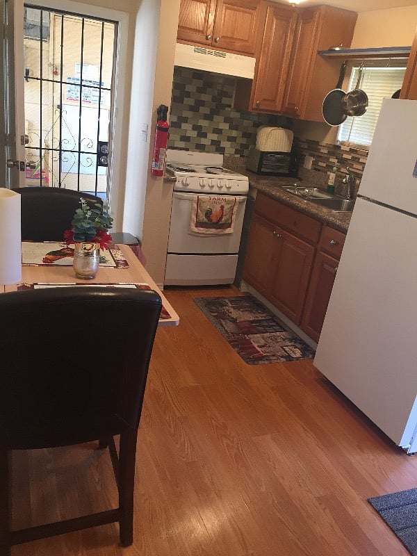 Exit door for emergency, located at the side of the cottage. Foldable table with 2 cushions chairs.