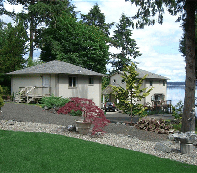 Cottage in front. View of owner-occupied residence in relationship to cottage.