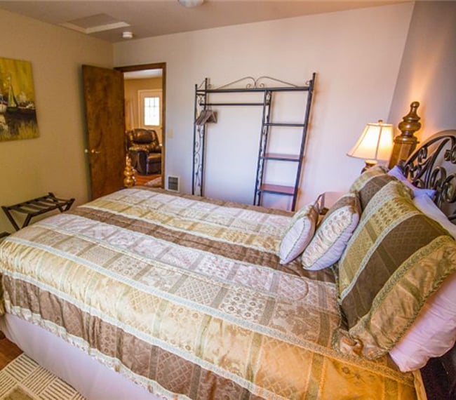 Zoom lens photo of bedroom. Queen bed, Portable Closet.