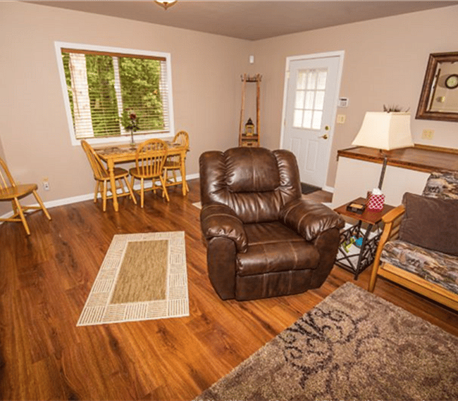 Zoom lens photo of living room area, includes picture of dining table