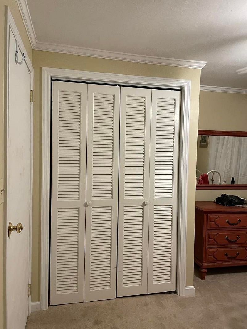 Storage closet with shelving and hot water heater