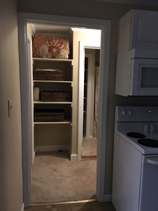 Hallway looking from kitchen with bathroom on back right