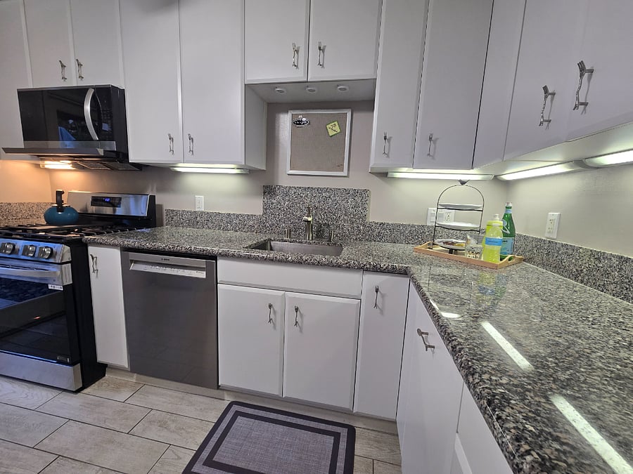 Kitchen with full size SS apliances and granite countertops.