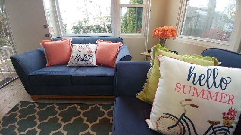 Living room with 2 sofas, wall storage and dining area!