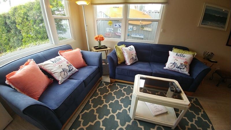 Living room with 2 sofas, dining area, lots of natural light!