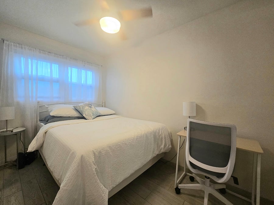 Small bedroom. Both bedrooms have blackout shades, a desk, office chair and ceiling fan.