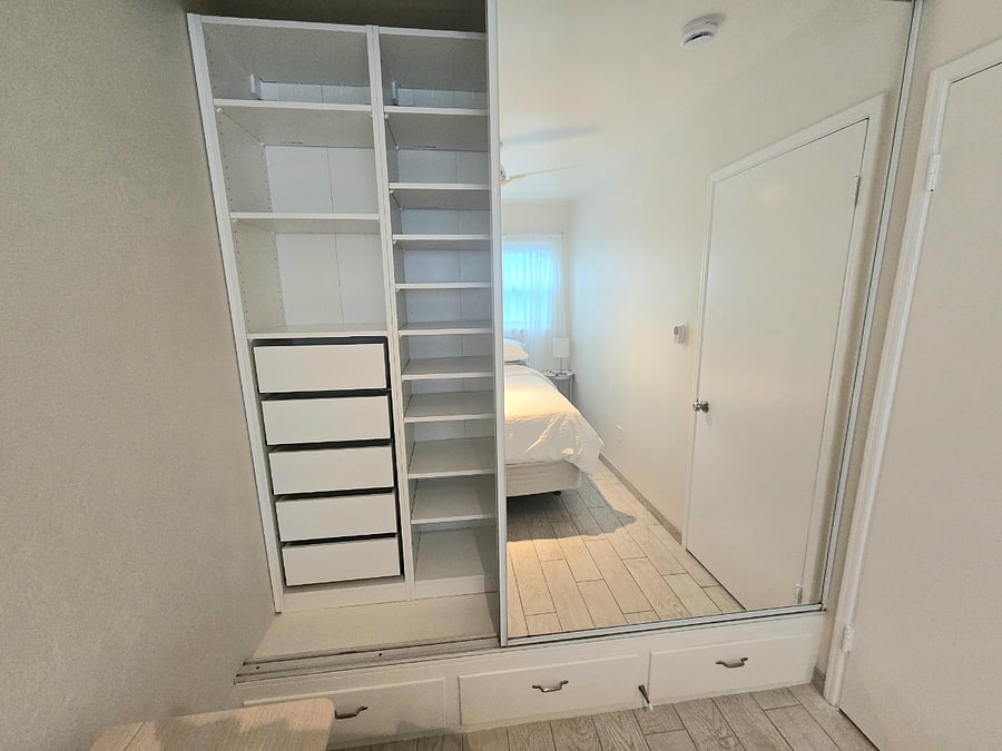 Both bedrooms have built in closets with drawers and hanging rods.