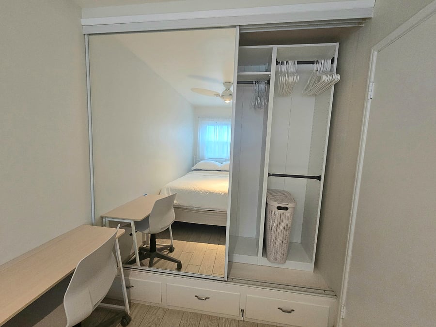 Both bedrooms have built in closets with drawers and hanging rods.