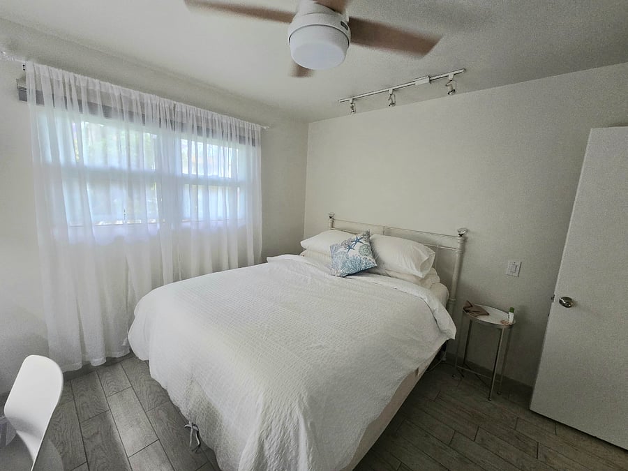 Large bedroom. Both bedrooms have blackout shades, a desk, office chair and ceiling fan.