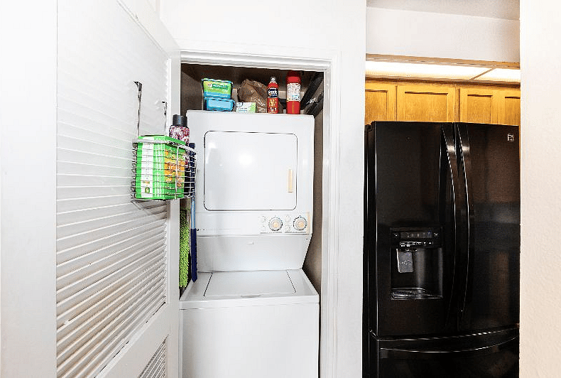 Stackable washer/dryer is behind door on previous photo to right of front door
