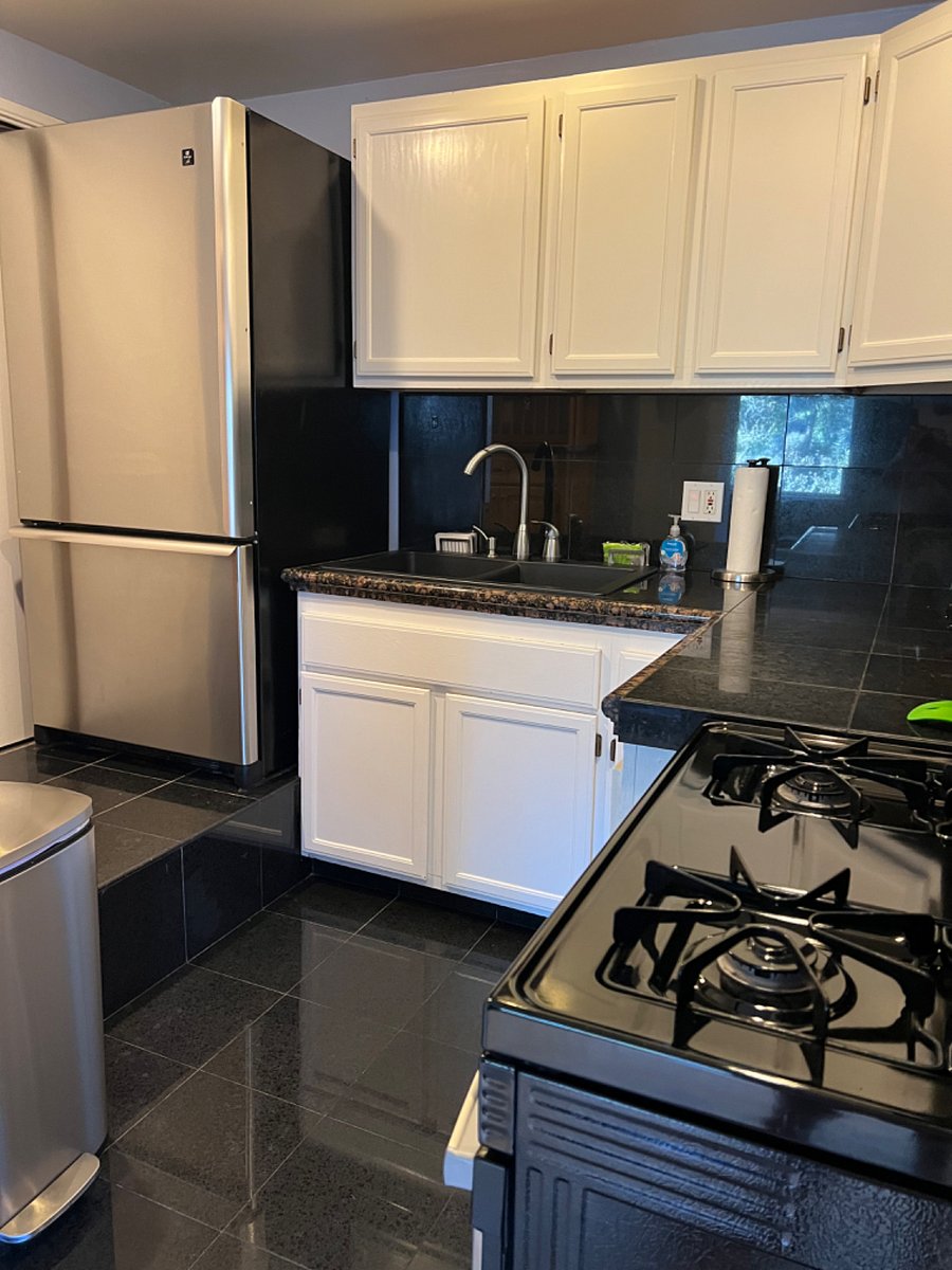 Kitchen with full size deluxe refrigerator and lots of cabinets & storage
