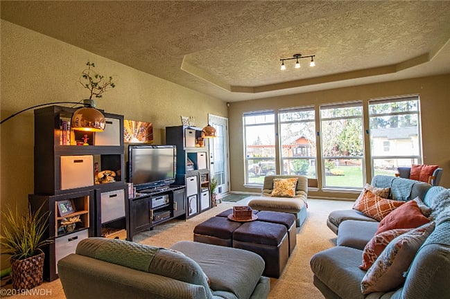 Family room has a wall of windows looking into the parklike backyard