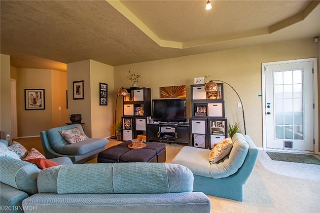 Hallway to left of family room leads to your bedroom and private bath