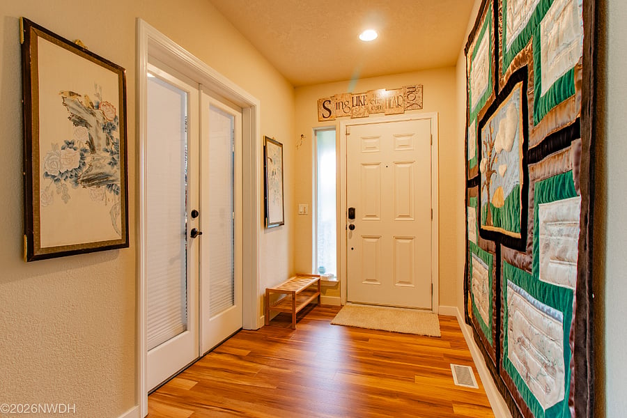 Main entry from front porch to Suite 1 featuring LVP flooring installed in 2025