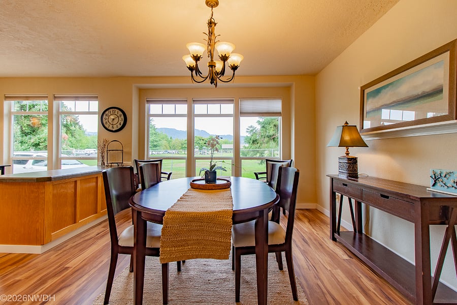 The spacious dining room looks out to an unobstructed view the Coburg Hills in the background, a church greenbelt in the foreground