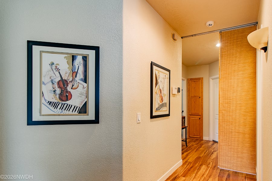 The Suite 1 bedroom is on the left and the bathroom on the right. At the end of the hall is the laundry room.