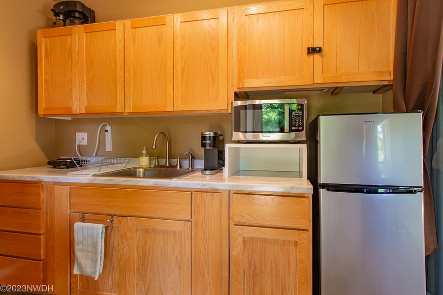 Kitchenette includes large mini refrigerator with separate freezer compartment