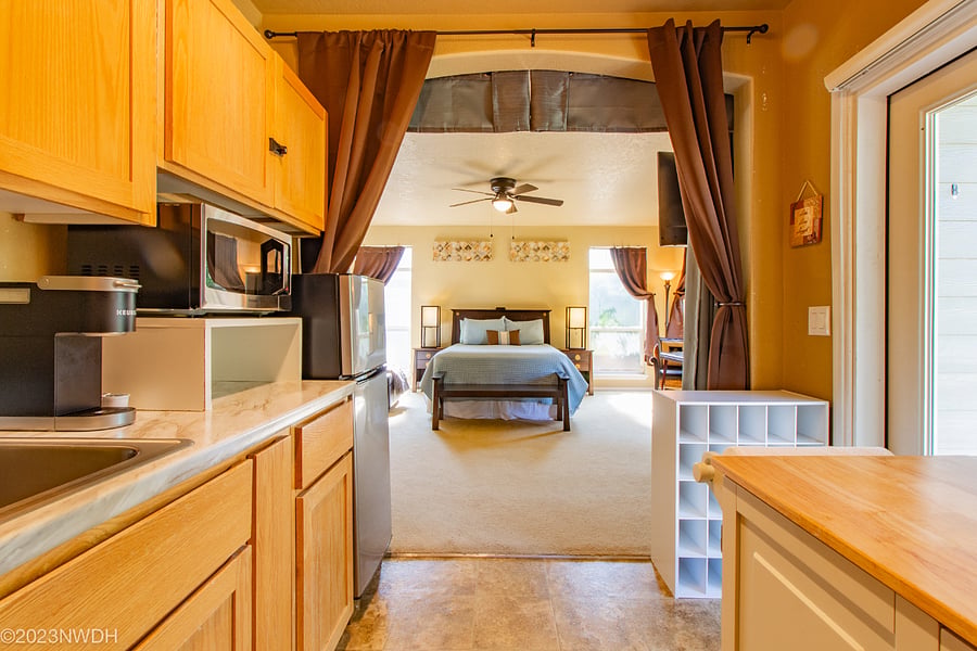 Kitchenette looking in large studio greatroom